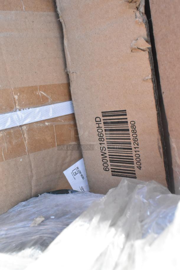 Cardboard boxes labeled "600WS1860HD," showing new items with minor scratches or dents. Contains shelf, table base, work table.