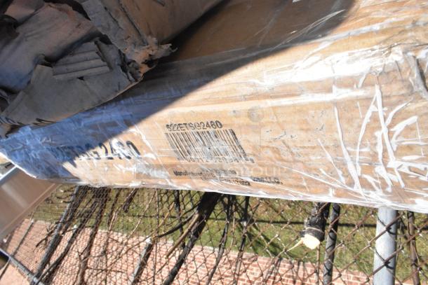 Sealed package with products including shelf, table base, work table. Box labeled 522ETSG2460, made in China. Scratch and dent items.