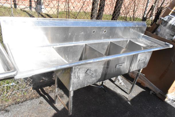 Commercial 3 bay stainless steel sink with dual drain boards, labeled wash, rinse, and sanitize; used condition.