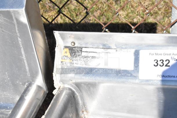 Commercial 2 Bay Sink with left side drain boards, stainless steel, visible product tag, some signs of wear.