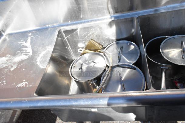 Commercial 3 bay sink with dual drain boards, stainless steel, includes pots and hoses, good condition, slight wear.