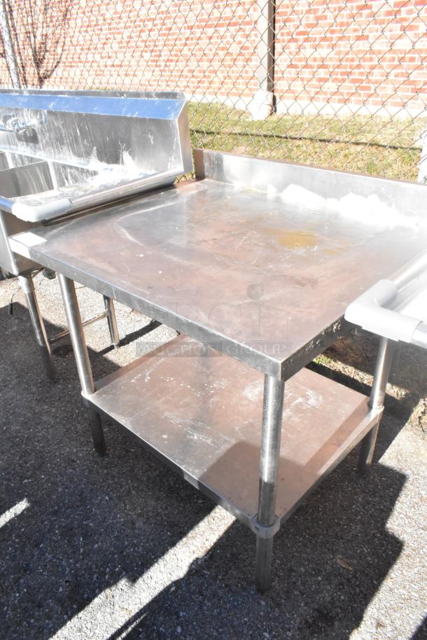 Regency 600TSB3036S commercial table with under shelf, stainless steel, sturdy build, used condition, minor surface wear.