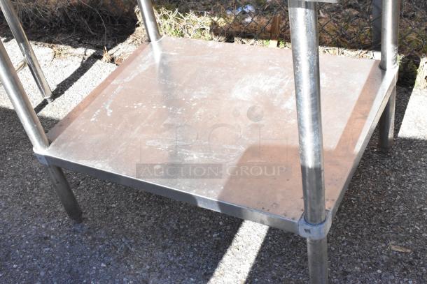 Regency 600TSB3036S commercial table with under shelf, stainless steel, good condition, outdoor setting.