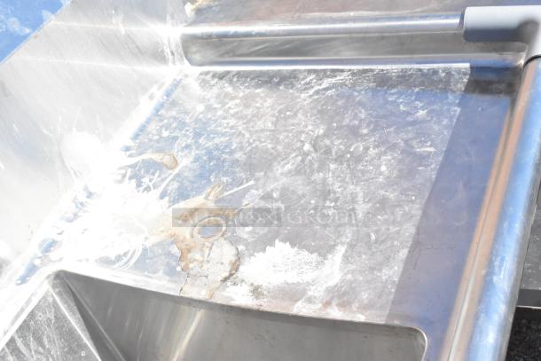 Commercial 3 bay sink with dual drain boards, stainless steel, visible wear and rust stains, ideal for heavy-duty use.