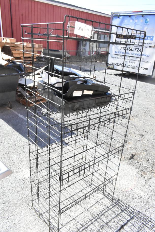 Black finish merchandising rack with attached cash register. Buyer must dismantle. Consider freight charges.