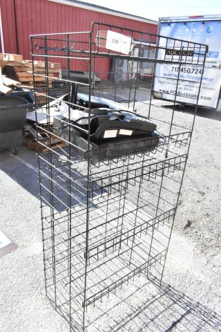 Black finish merchandising rack with attached cash register. Buyer must dismantle. Consider freight charges.