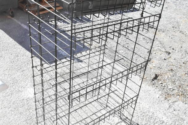 Black finish merchandising rack with integrated cash register, wire grid structure, in used condition. Buyer must dismantle.