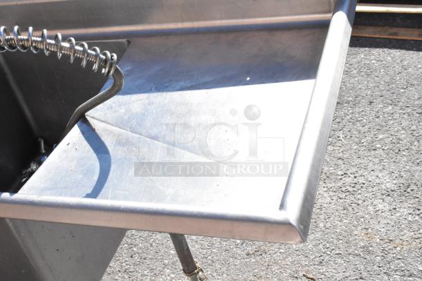 Commercial 3 bay sink with left side drain board, stainless steel, minor wear, suitable for restaurant use.