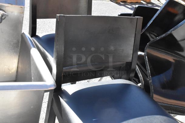 Set of black dining and bar chairs, and tables, showing moderate wear, suitable for various seating needs.