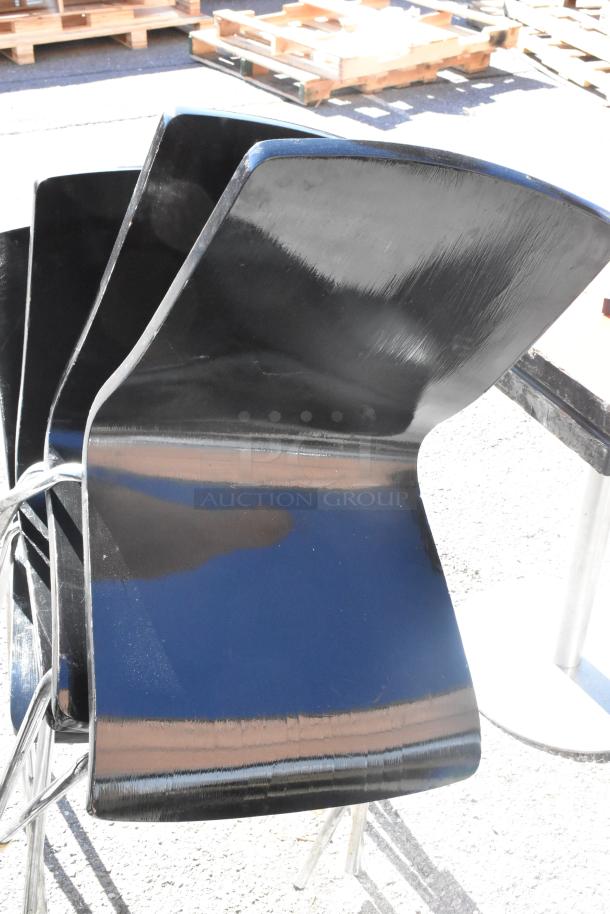 Set of black chairs with sleek, modern design. Includes 2 bar height, 8 dining height chairs, and 4 tables. Good condition.