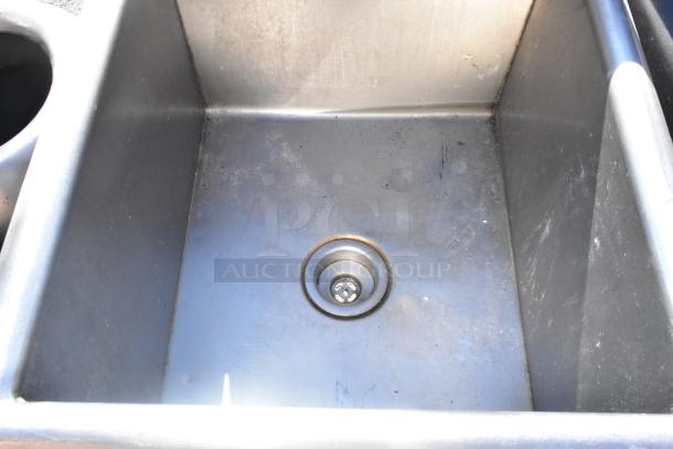 Commercial single bay stainless steel sink, used condition, visible drain. Ideal for professional kitchen setups.