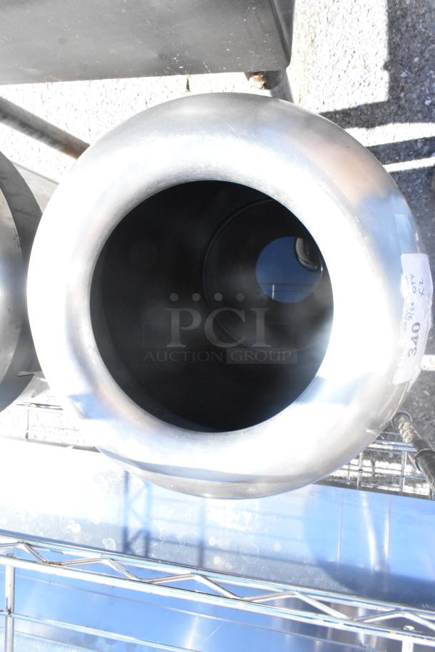 Two chrome finish trash can shells, excellent condition, reflective surface, cylindrical shape, with a visible label indicating auction details.