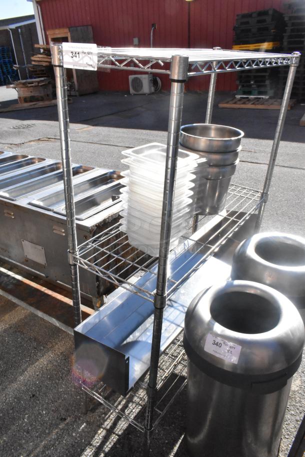 Chrome finish 3-tier wire shelving unit with bins, trays, and bowls. Buyer must dismantle. Consider freight charges.