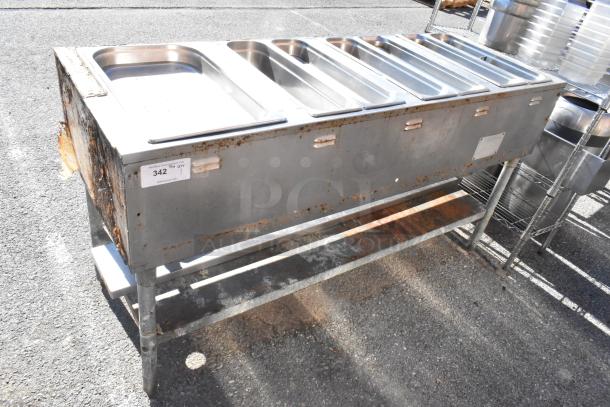 Commercial 4 bay steam table with rust and wear, featuring stainless steel pans and an undershelf. Label: "342 QTY".