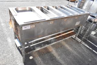 Commercial 4 bay steam table with rust and wear, featuring stainless steel pans and an undershelf. Label: "342 QTY".