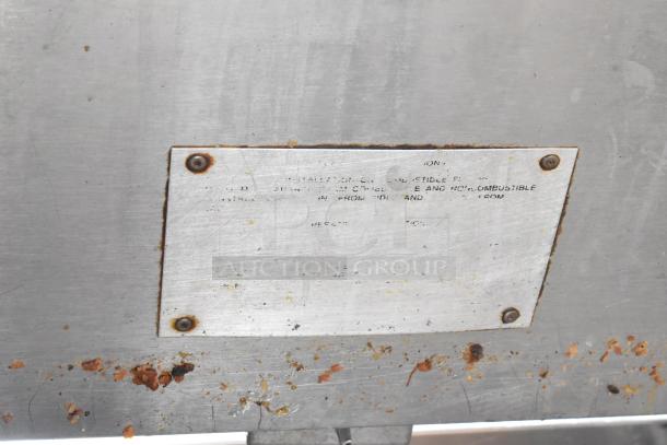 Commercial 4 Bay Steam Table w/ under shelf shown with visible metal plate, some surface rust, and stains.