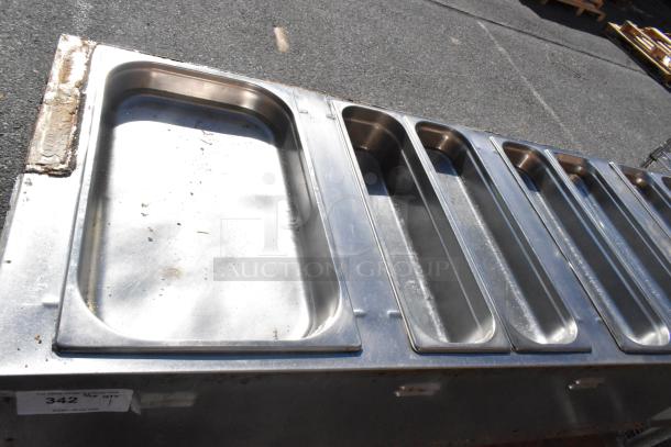 Commercial 4 bay steam table with under shelf. Stainless steel, used condition, label reads "342, QTY 1".