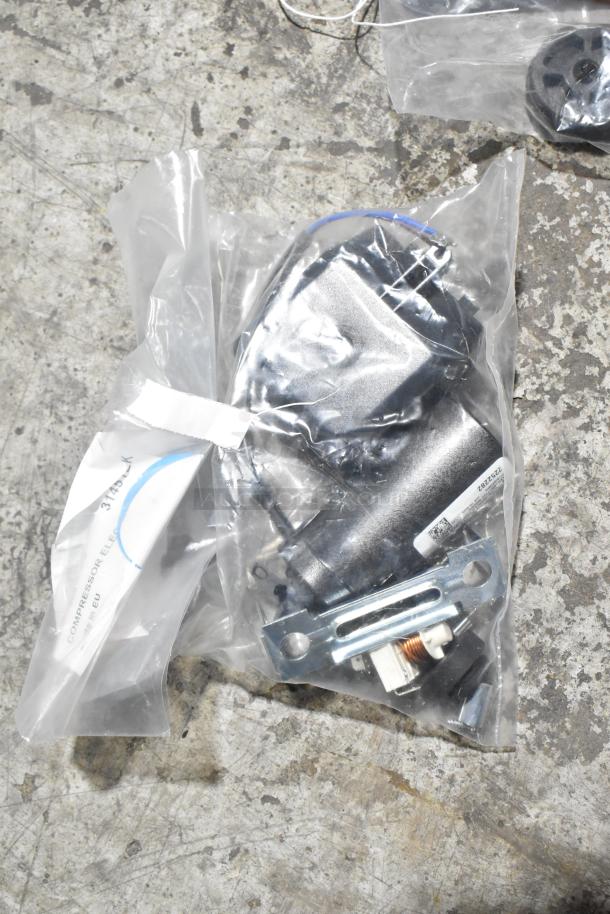 Plastic-wrapped compressor assembly, labeled "Compressor Electric," in new condition with minor cosmetic imperfections.