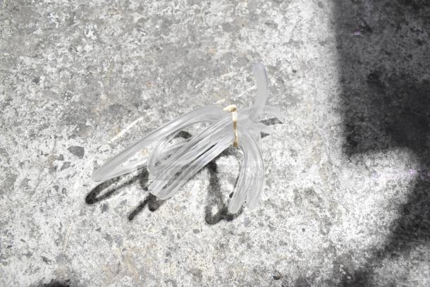 Clear tubing bundle, part of auction lot with Flojet 20578007C hardware and cords, on textured surface.