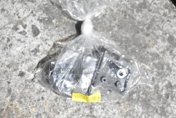 Bag containing Flojet 20578007C hardware and cords, sealed in plastic. Various items visible, in used condition.