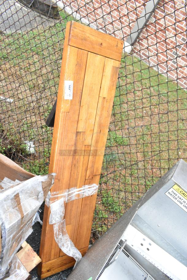 Wooden butcher block tabletop with visible legs, showing natural wood grain. Good condition, small label with "976" marking.