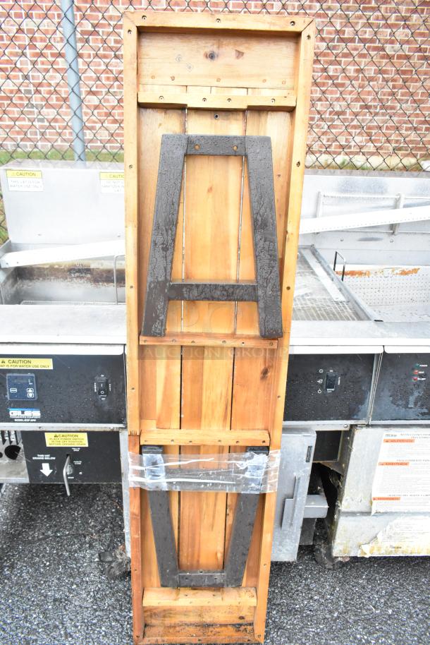 Wooden butcher block tabletop with folding legs, sturdy construction, metal brackets, good condition, ready for use.