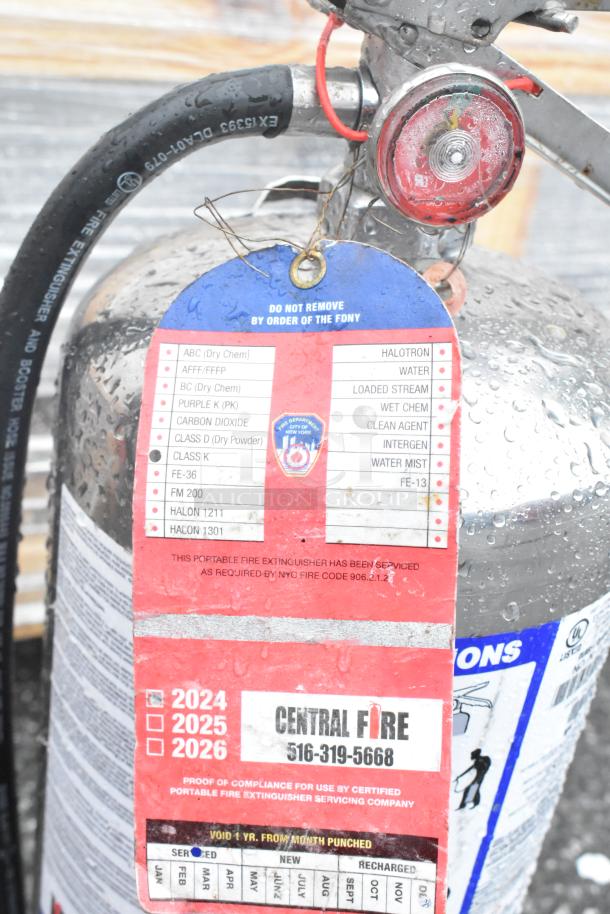 Two fire extinguishers with detailed service tags by Central Fire, model EX15933, in good condition, buyer pickup only.