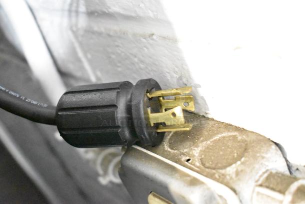 Plug of a 2025 True GDM-72F-HC freezer showing a black, three-prong electrical plug suitable for 115/208-230 Volts, 1 Phase.