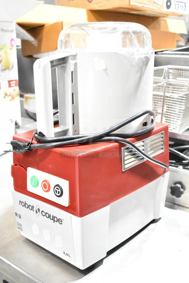 Brand new Robot Coupe R2N food processor with 3 Qt. gray bowl, continuous feed, and 2 discs. Minor scratch and dent.