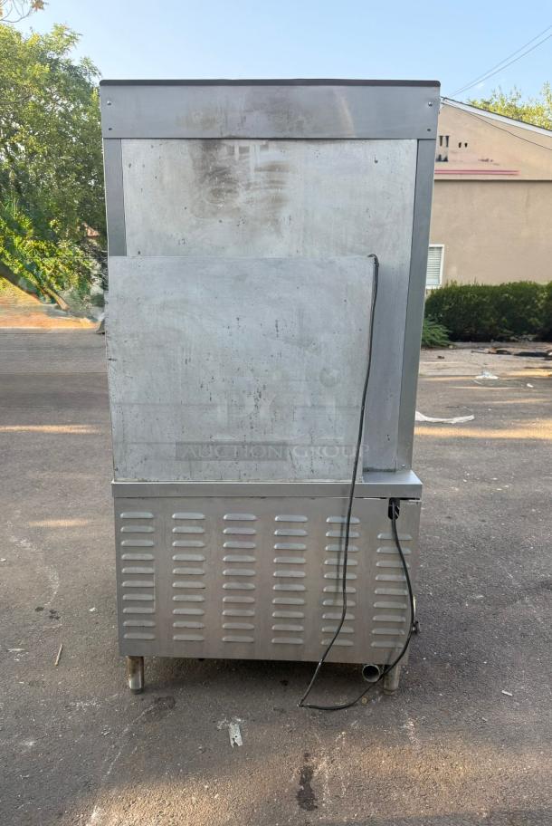 Market Forge ST-24M36G convection steamer, 24-pan capacity, stainless steel, freestanding, visible exterior wear.