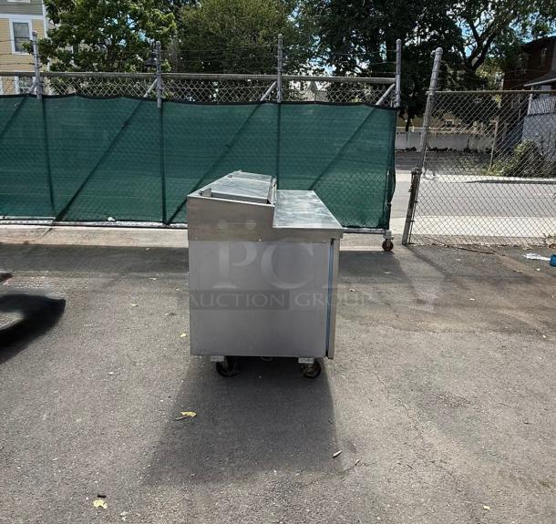 Delfield 18672PTLP 72" two-door refrigerated pizza prep table, stainless steel, raised rail, used condition, outdoor setting.