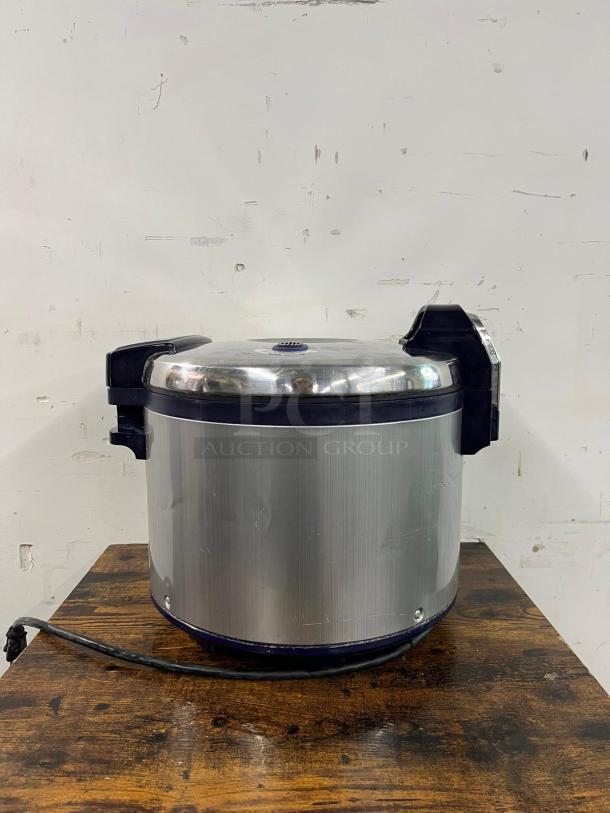 Thunder Group SEJ3201 stainless steel 30-cup rice cooker/warmer on a wooden table. NSF/ETL certified, power cord visible.
