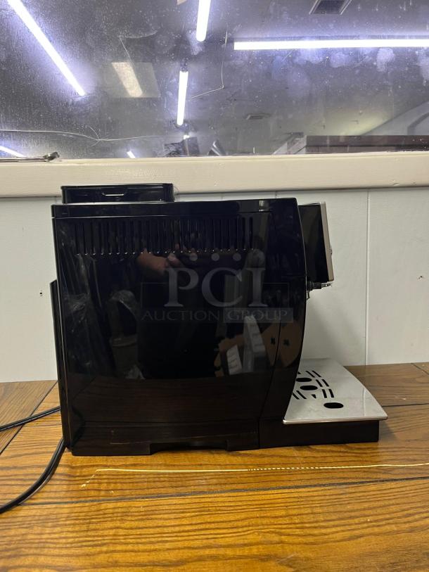 De'Longhi Magnifica S Automatic Espresso Machine with built-in grinder, black finish, gently used condition.