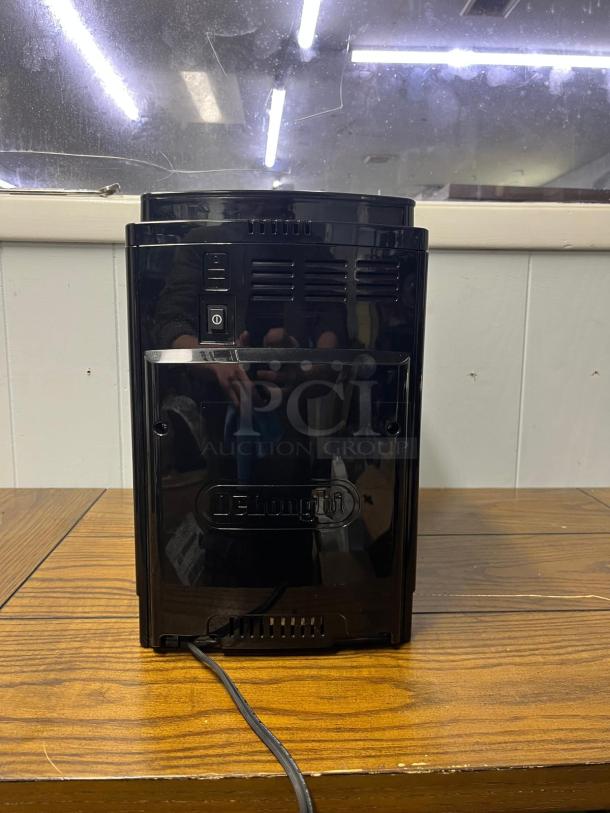 De'Longhi Magnifica S Automatic Espresso Machine, sleek design, built-in grinder, De'Longhi logo visible, good condition.