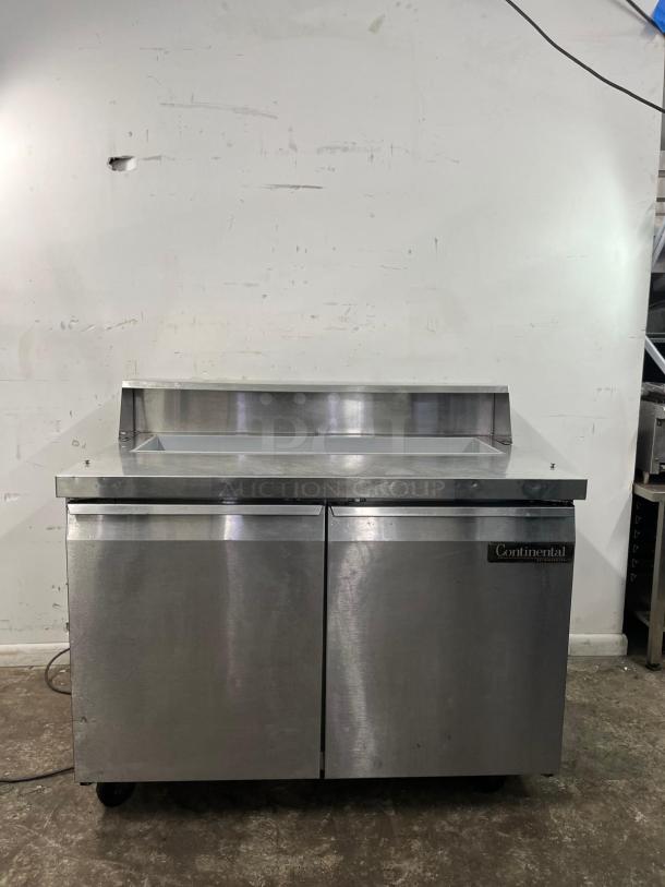 Continental SW48-12 refrigerated sandwich prep unit, 48", 13.4 cu ft, stainless steel, dual doors, on casters, good condition.