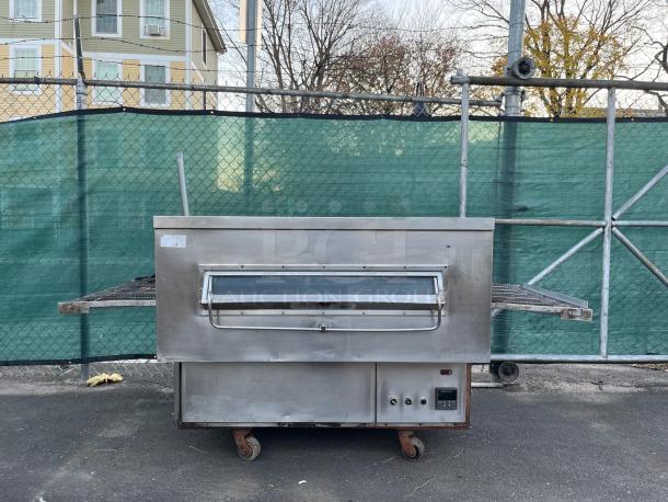 Middleby Marshall PS360G gas-fired impingement conveyor oven, stainless steel, used, outdoor setting, on wheels.