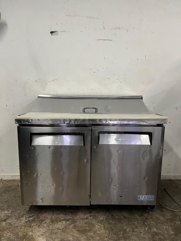 Turbo Air MST-48 M3 Series 48in prep table, stainless steel, dual compartments, visible wear, branding label lower right.