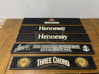 Set of bar runners featuring Heineken, Hennessy, Sailor Jerry, and Three Chord logos. Black rubber, good condition.