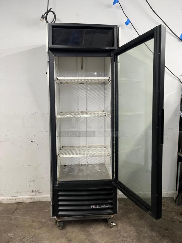 TRUE GDM-19T-LD 27" black refrigerated glass door merchandiser with LED lighting, open door, includes travel case.