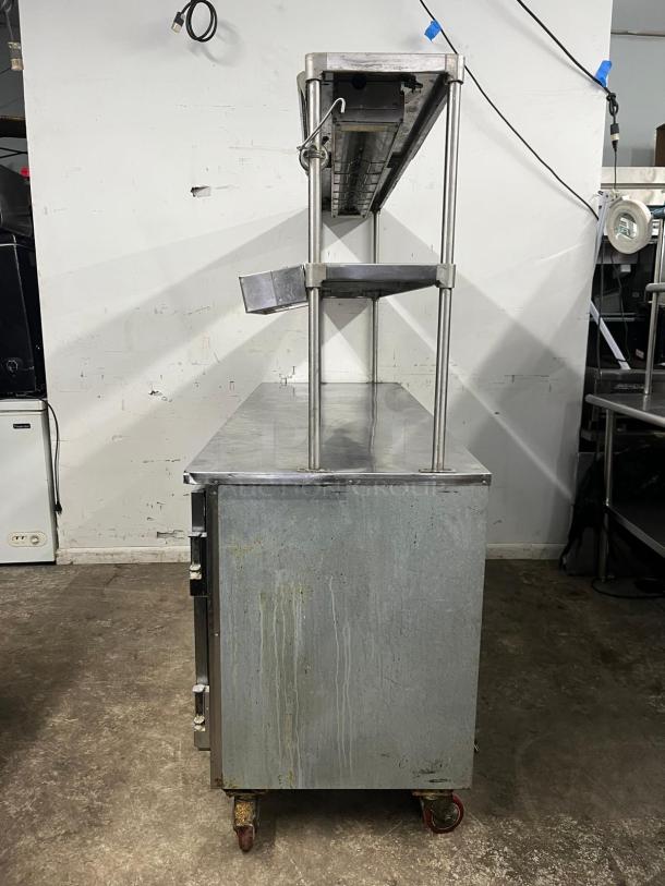 Leader LB72 72" low boy worktop refrigerator, features two full doors, half door, double shelves, heat lamp, worn condition.