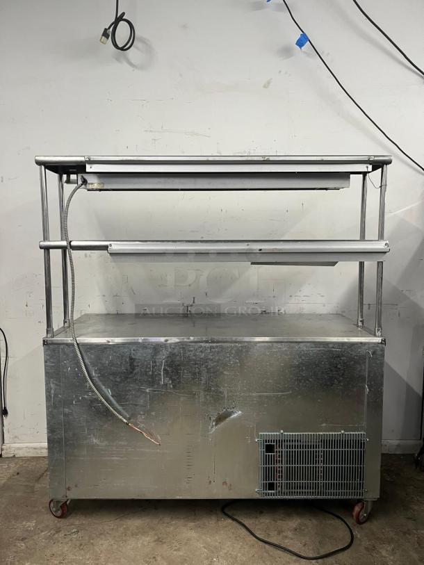 LEADER LB48 under counter refrigerator with 2 full, 1 half door, double shelves, heat lamp; visible wear, metal casing.