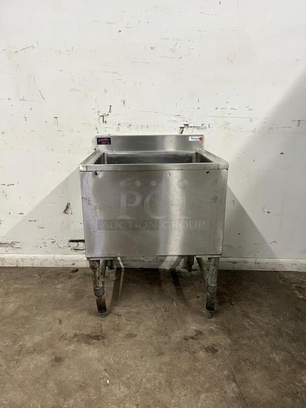 COLD PLATE 24" stainless steel ice bin with drain, used condition, visible wear on legs, manufacturer label attached.