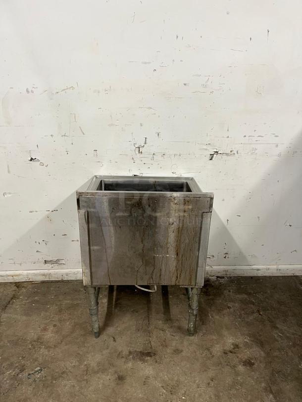 Stainless steel COLD PLATE 24-inch ice bin with drain, visible wear and stains, durable design for commercial use.