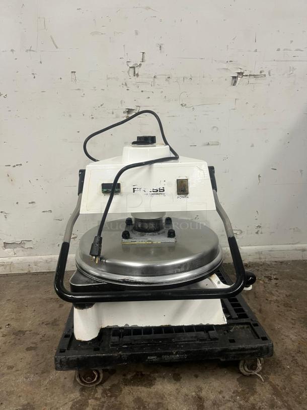DOUGH PRO Pizza Press DP1100, electric, white and stainless steel, used condition, visible power cord, on wheeled base.