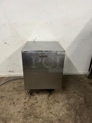 TRAULSEN UHT27-L 27" undercounter fridge, stainless steel, left hinged door, used condition, logo on front, on wheels.