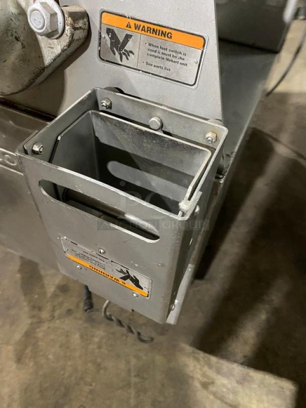 Hobart MG1532-1 commercial meat grinder, 150 lb capacity, electromechanical controls, air-drive foot switch, warning labels visible.