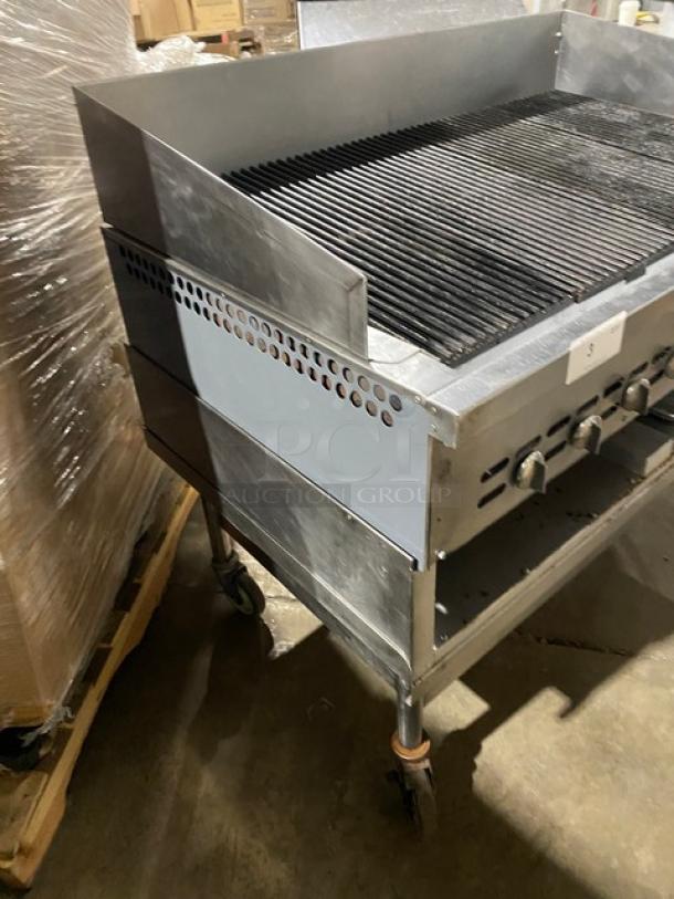 Bakers Pride stainless steel gas char broiler with back/side splash, undershelf cart on casters; used condition.