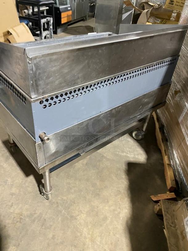 Bakers Pride stainless steel gas char broiler with back and side splash, single undershelf stand. On casters, in used condition.