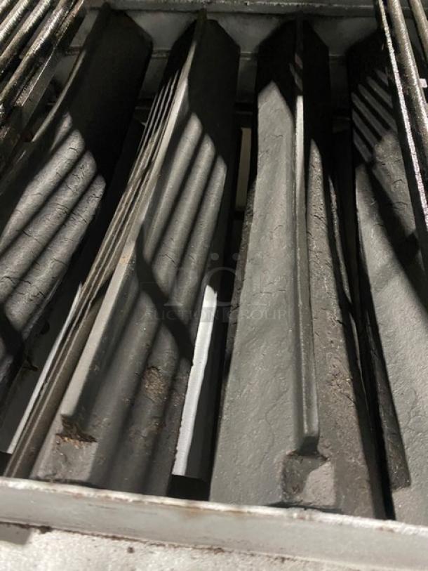 Bakers Pride stainless steel gas char broiler with radiant design. Features back and side splash, undershelf stand, on casters.