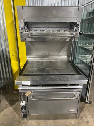 Jade Range commercial stainless steel gas multi-cooking range with plancha griddle, backsplash, overhead broiler, and oven.